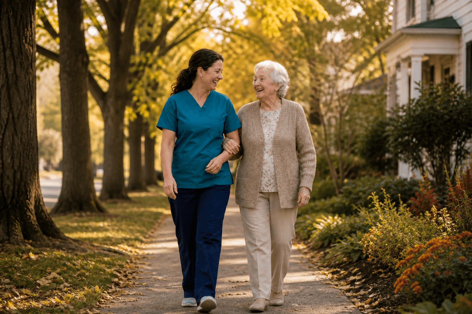 Caregiver and elderly client walking together outdoors on a tree-lined sidewalk